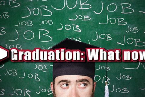job written on a green board with a student standing in front