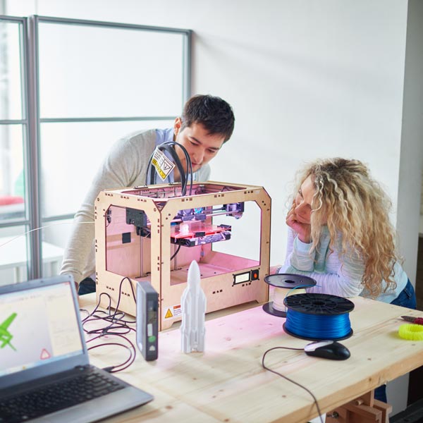 manufacturing students with 3D printer