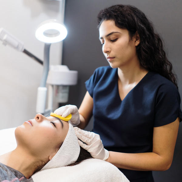 person cleaning another person's face