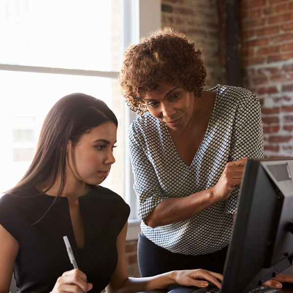 standing person explaining something to sitting person