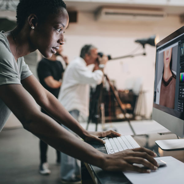 person editing photos on computer