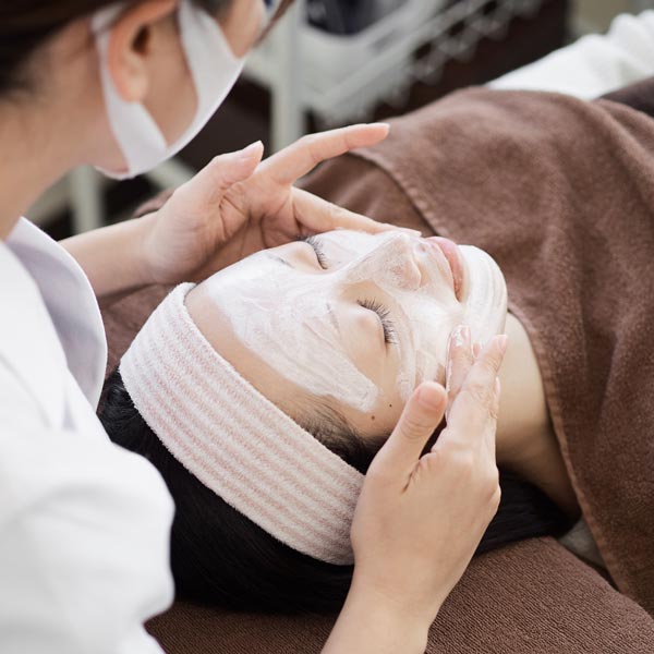 woman receiving a facial service
