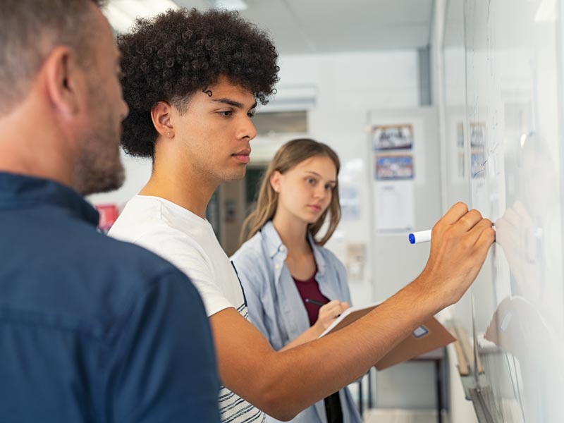 students writing on white board