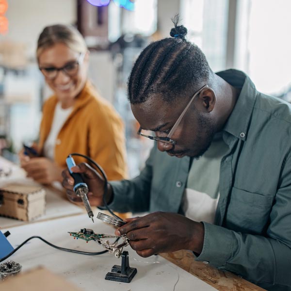 man soldering electronics