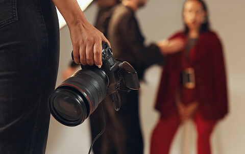 Person Holding Camera for Professional Photography Program