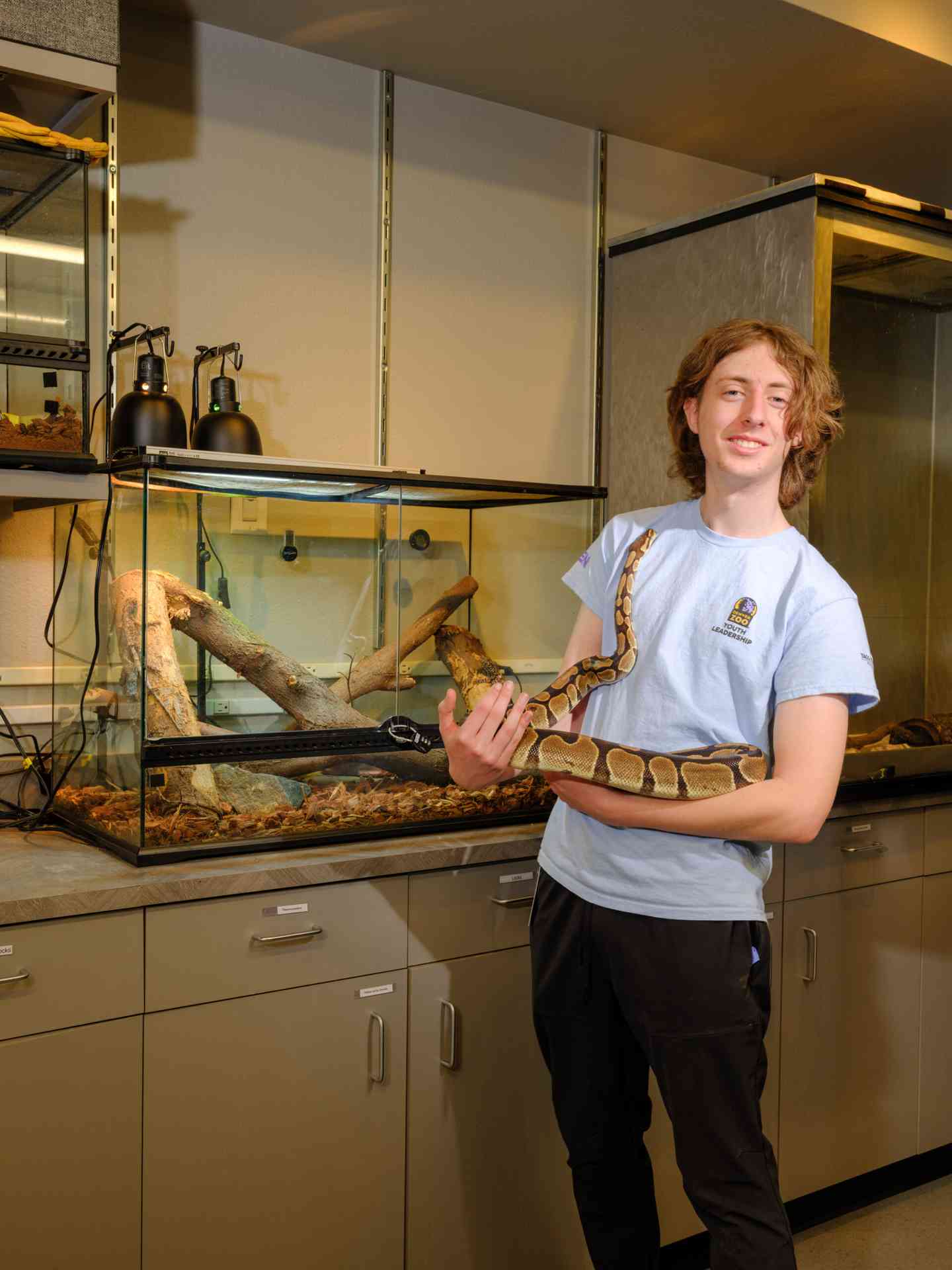 Student learning animal care handling in the Aurora, CO, lab
