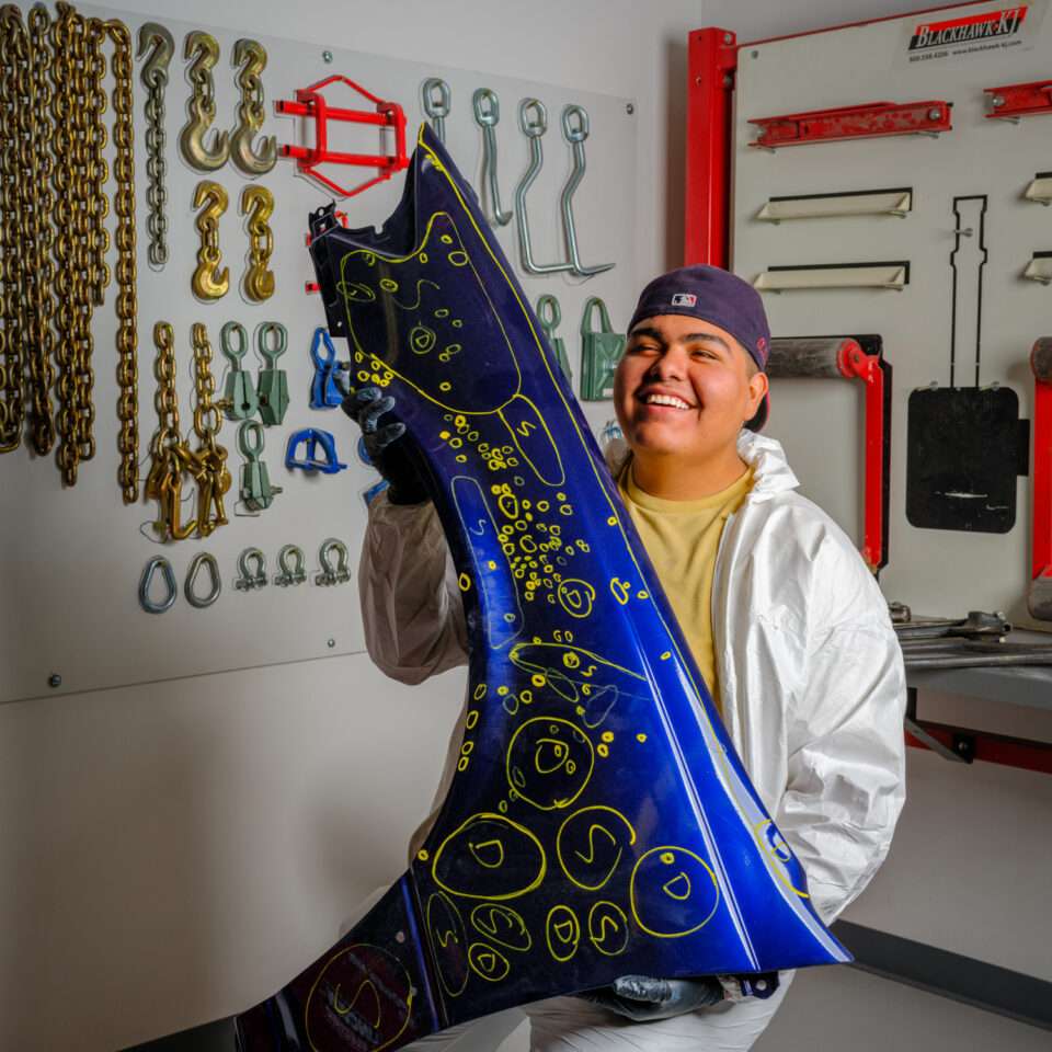 Collision repair student learning non‑structural auto body techniques in Aurora, CO
