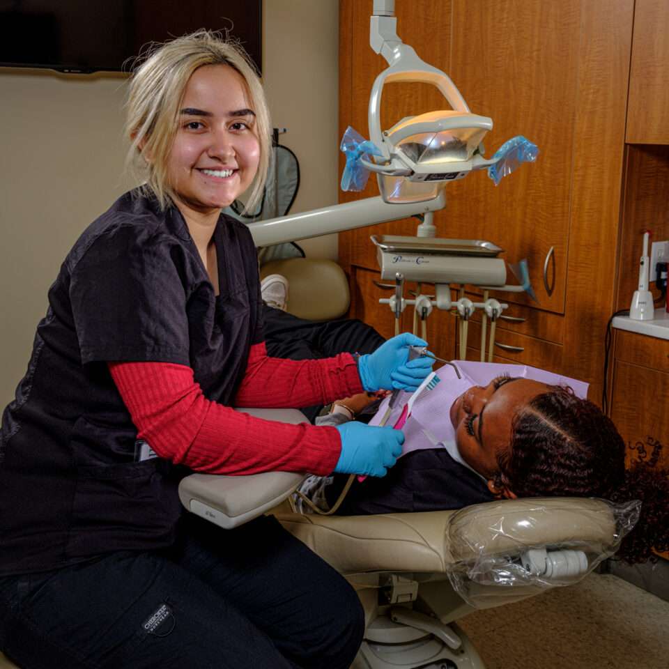 Dental assisting student practicing clinical skills in Aurora, CO

