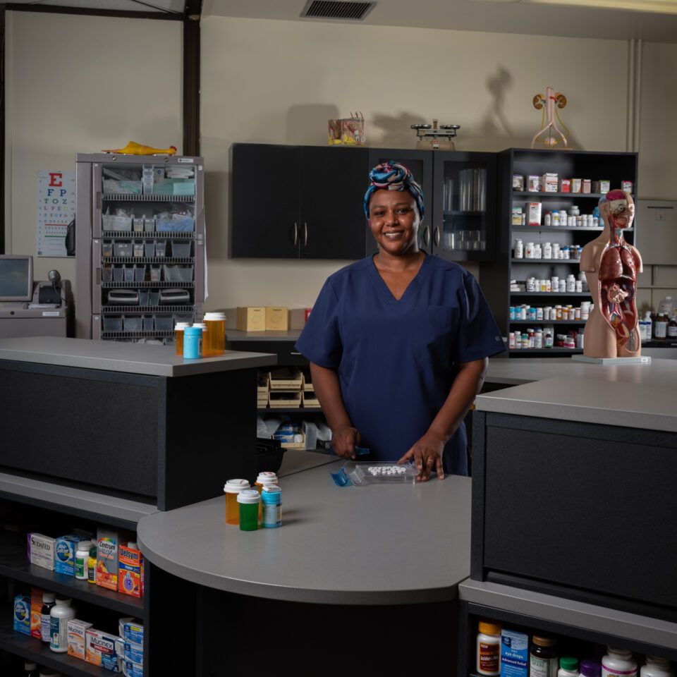 Pharmacy technician student practicing medication preparation in Aurora, CO
