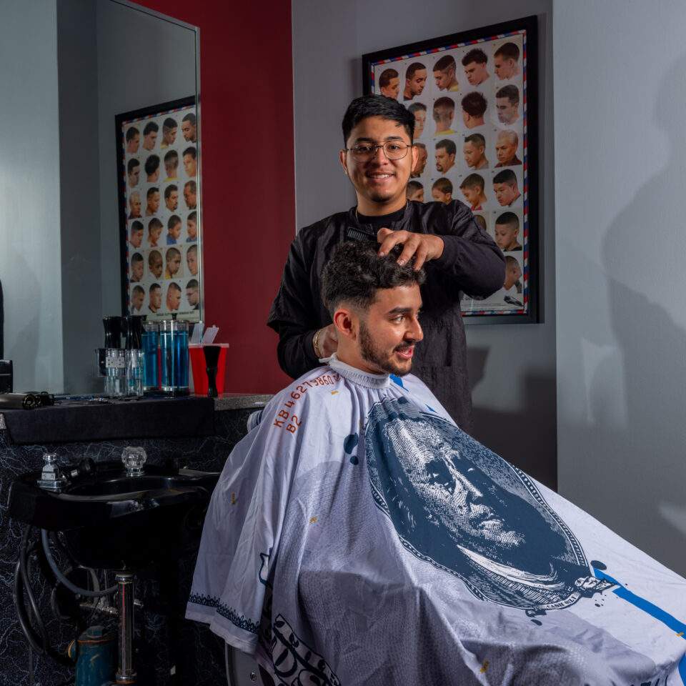 Hairstylist working on a client’s hair in a salon